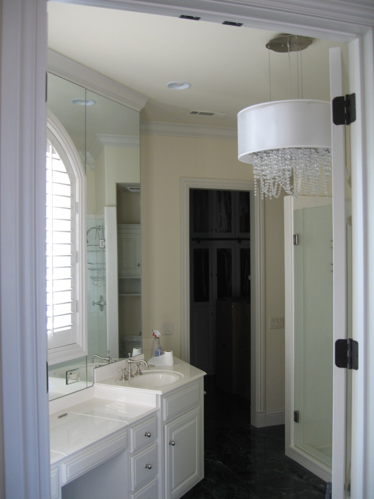 Alcove shower - mid-sized transitional 3/4 dark wood floor and brown floor alcove shower idea with recessed-panel cabinets, white cabinets, beige walls, an undermount sink, quartzite countertops and a hinged shower door