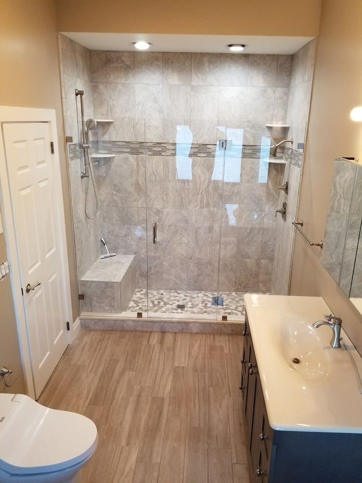 Design ideas for a large modern master wet room bathroom in New York with grey cabinets, a hot tub, gray tile, stone tile, porcelain floors, zinc benchtops, grey floor, a bidet and an integrated sink.