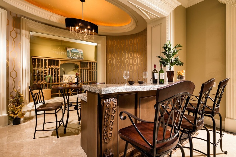 This is an example of a traditional single-wall seated home bar in Los Angeles with beaded inset cabinets and medium wood cabinets.
