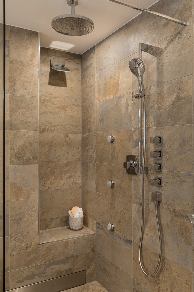 Bild på ett badrum med dusch, med en kantlös dusch, beige kakel, marmorkakel, beige väggar, marmorgolv, kaklad bänkskiva, beiget golv och med dusch som är öppen
