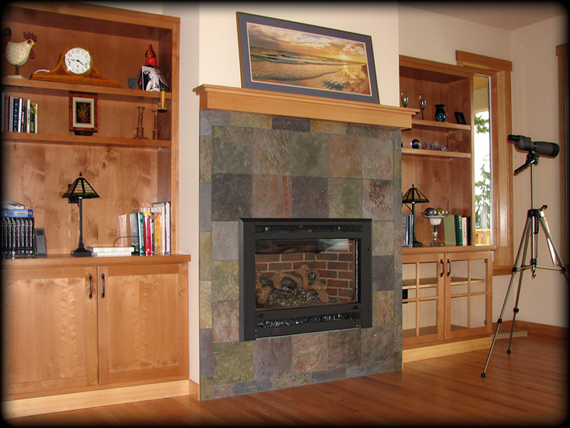 This is an example of a mid-sized arts and crafts enclosed living room in Seattle with medium hardwood floors, a standard fireplace and a stone fireplace surround.