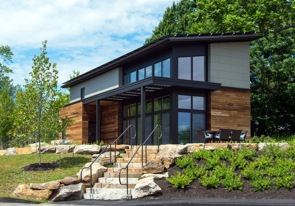 This is an example of a large contemporary two-storey exterior in Portland Maine with mixed siding and a shed roof.