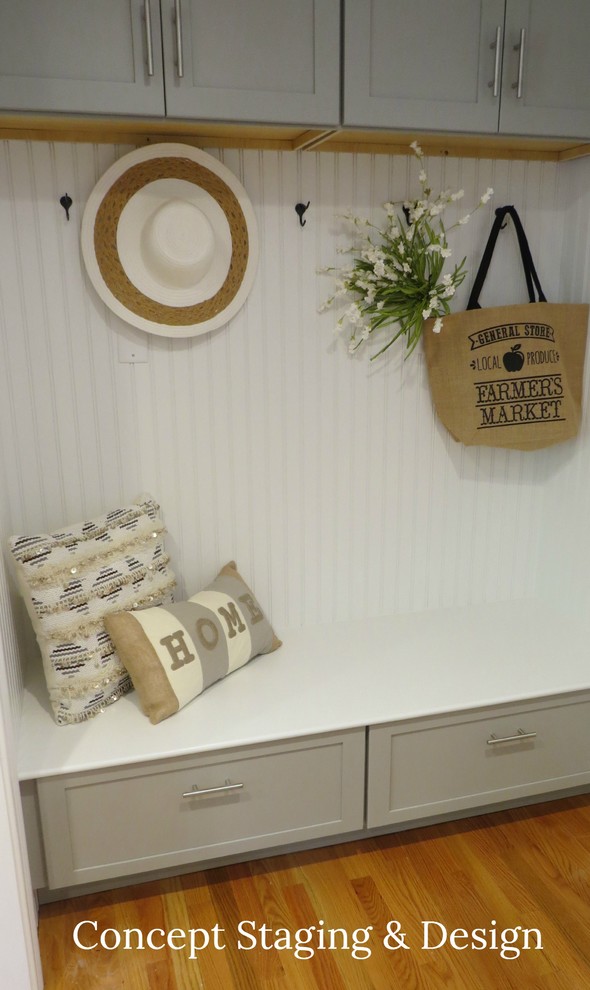 Example of a transitional medium tone wood floor entryway design with gray walls