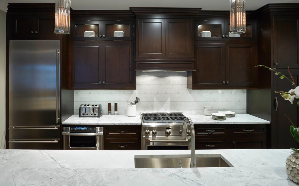 Kitchen - small transitional galley kitchen idea in Chicago with an undermount sink, flat-panel cabinets, dark wood cabinets, granite countertops, gray backsplash and stainless steel appliances