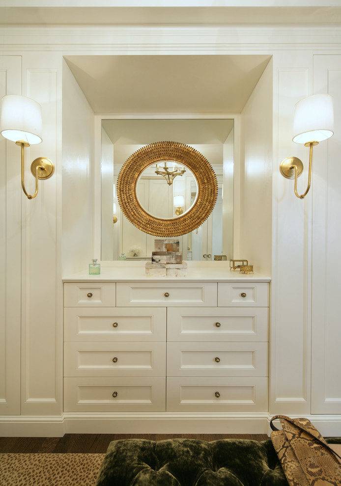 Large transitional women's dressing room in New York with recessed-panel cabinets, white cabinets, dark hardwood floors and brown floor.