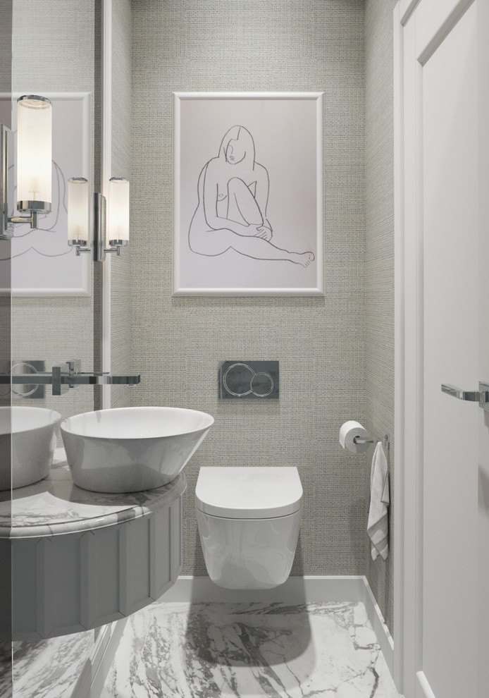 Design ideas for a small modern powder room in London with furniture-like cabinets, beige cabinets, a wall-mount toilet, black and white tile, ceramic tile, beige walls, ceramic floors, a vessel sink and marble benchtops.
