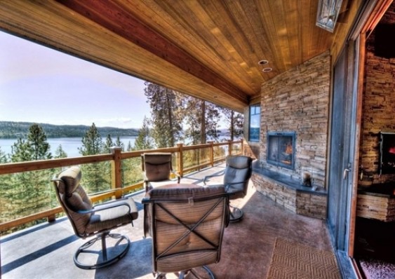 Deck - large rustic deck idea in Seattle with a fire pit and a roof extension