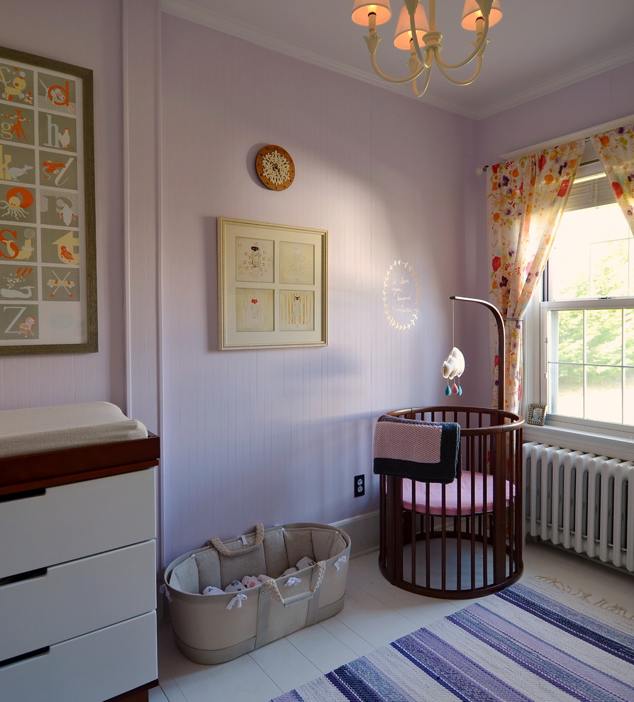 Design ideas for a scandinavian nursery for girls in New York with pink walls and painted wood floors.