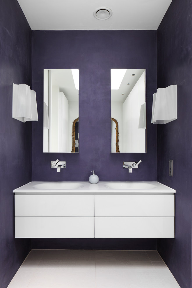 Mid-sized contemporary master bathroom in London with a wall-mount sink, white tile, purple walls, flat-panel cabinets, white cabinets, laminate benchtops, a freestanding tub, an open shower, a wall-mount toilet and porcelain floors.