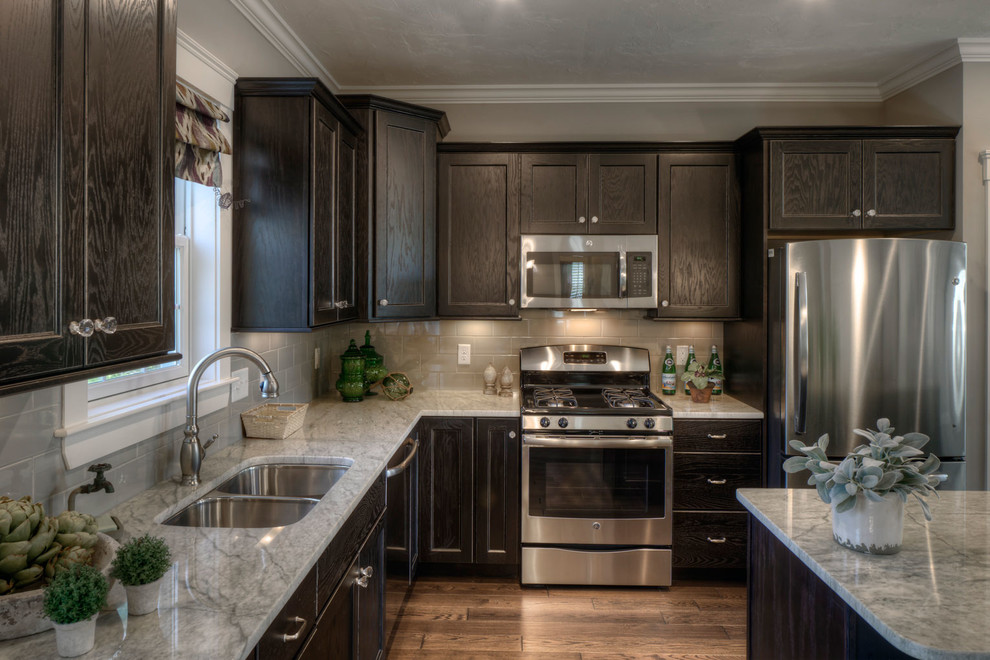 Inspiration for a mid-sized traditional kitchen in Boston with a double-bowl sink, raised-panel cabinets, dark wood cabinets, granite benchtops, stainless steel appliances, medium hardwood floors and with island.