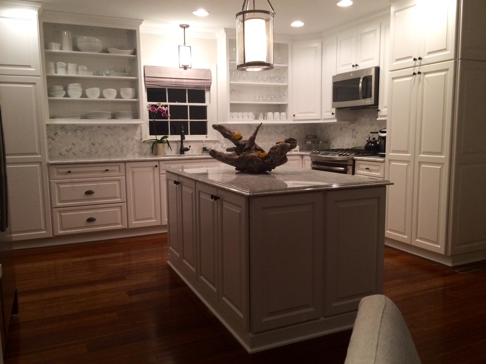 Eat-in kitchen - huge transitional u-shaped dark wood floor eat-in kitchen idea in Charlotte with an undermount sink, raised-panel cabinets, white cabinets, granite countertops, gray backsplash, porcelain backsplash, stainless steel appliances and an island