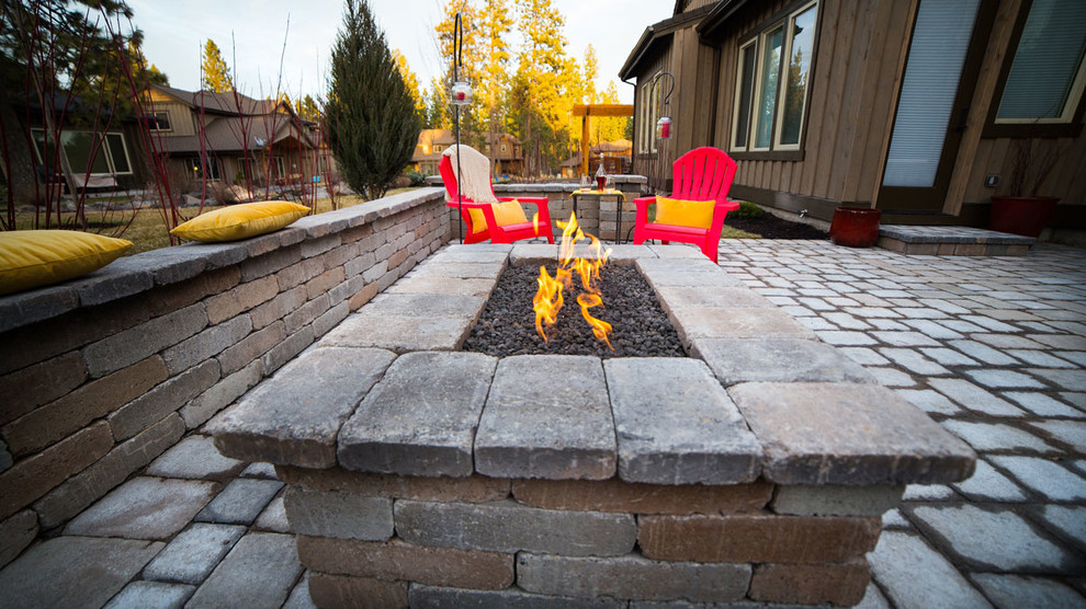 Inspiration for a large contemporary backyard concrete paver patio remodel with a fire pit and no cover