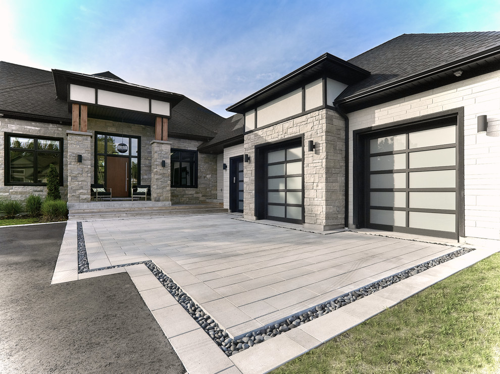 Design ideas for a contemporary front yard driveway in Toronto with concrete pavers.