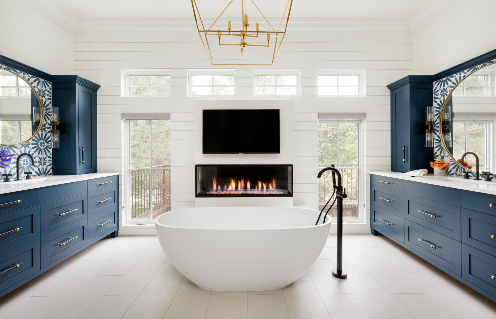 Photo of an expansive eclectic master bathroom in Denver with furniture-like cabinets, blue cabinets, a freestanding tub, a double shower, cement tile, engineered quartz benchtops, a hinged shower door, white benchtops, a double vanity, a built-in vanity and planked wall panelling.