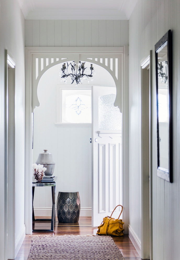 Photo of a beach style entryway in Melbourne with grey walls and dark hardwood floors.