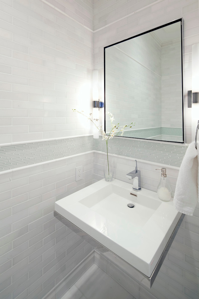 This is an example of a contemporary bathroom in Calgary with a wall-mount sink, white tile and subway tile.