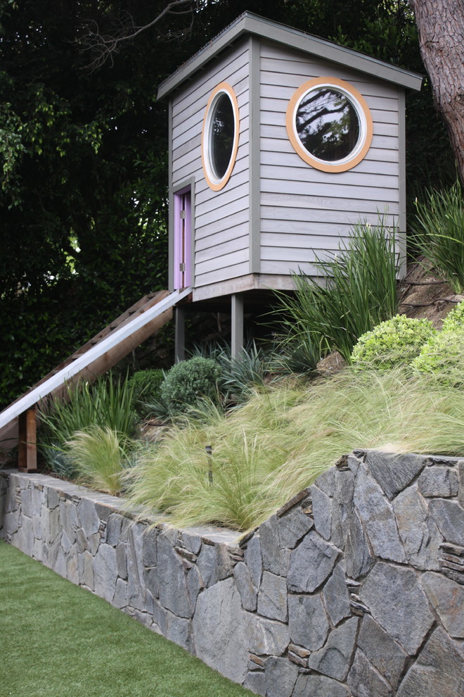This is an example of a traditional garden in Orange County with with outdoor playset.