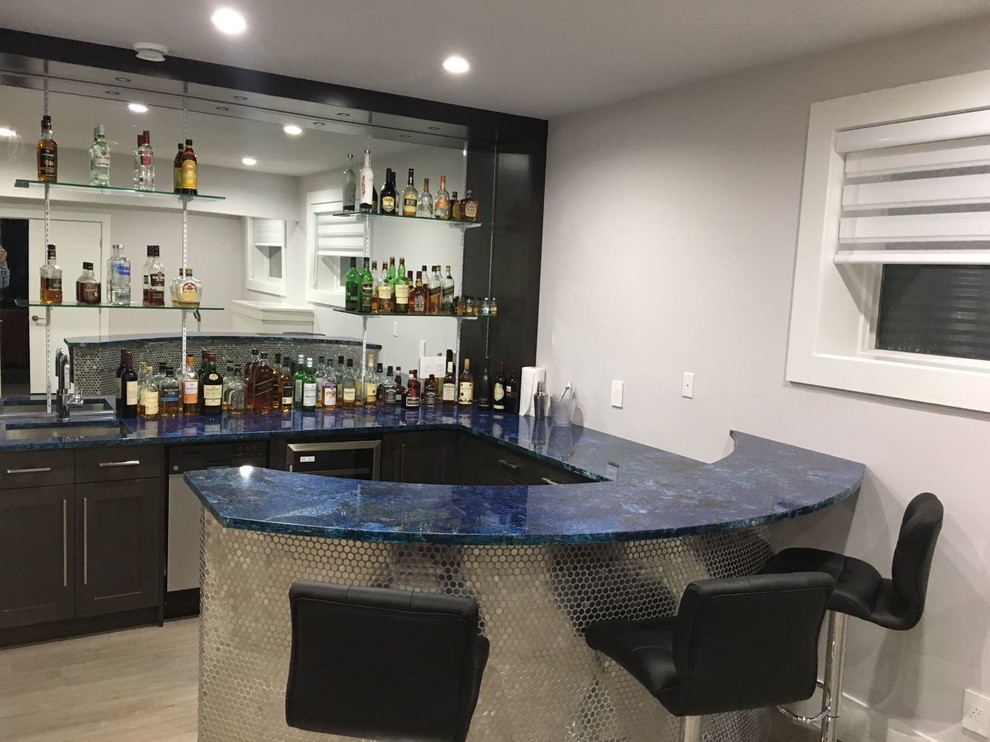 Inspiration for a mid-sized modern seated home bar in Calgary with shaker cabinets, dark wood cabinets, mirror splashback, light hardwood floors, brown floor and blue benchtop.