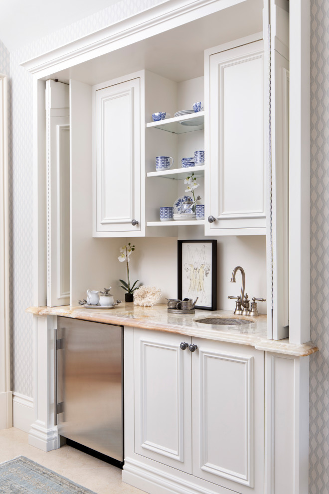 Beach style single-wall beige floor wet bar photo in Philadelphia with an undermount sink, recessed-panel cabinets, white cabinets, white backsplash and beige countertops