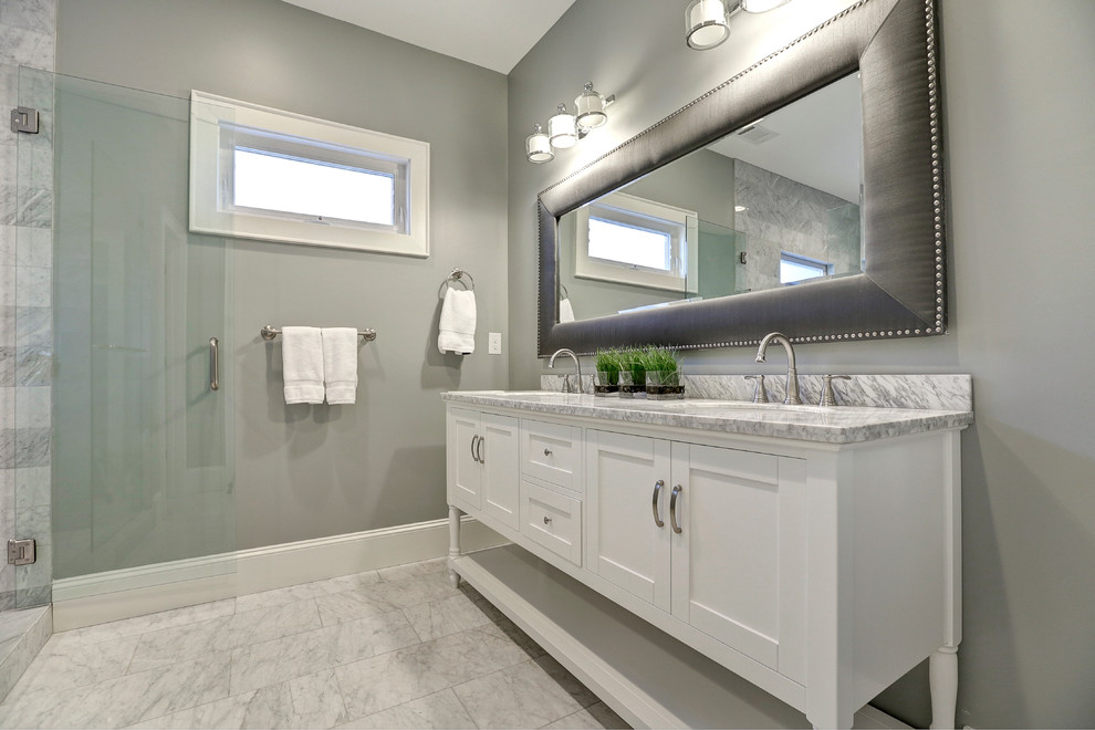 Photo of a mid-sized transitional bathroom in Atlanta with marble floors, furniture-like cabinets, white cabinets, a corner shower, grey walls and an undermount sink.