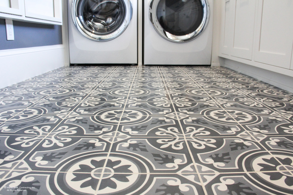 Example of a large transitional u-shaped ceramic tile and gray floor dedicated laundry room design in Other with a farmhouse sink, shaker cabinets, white cabinets, wood countertops, white backsplash, ceramic backsplash, blue walls and an integrated washer/dryer