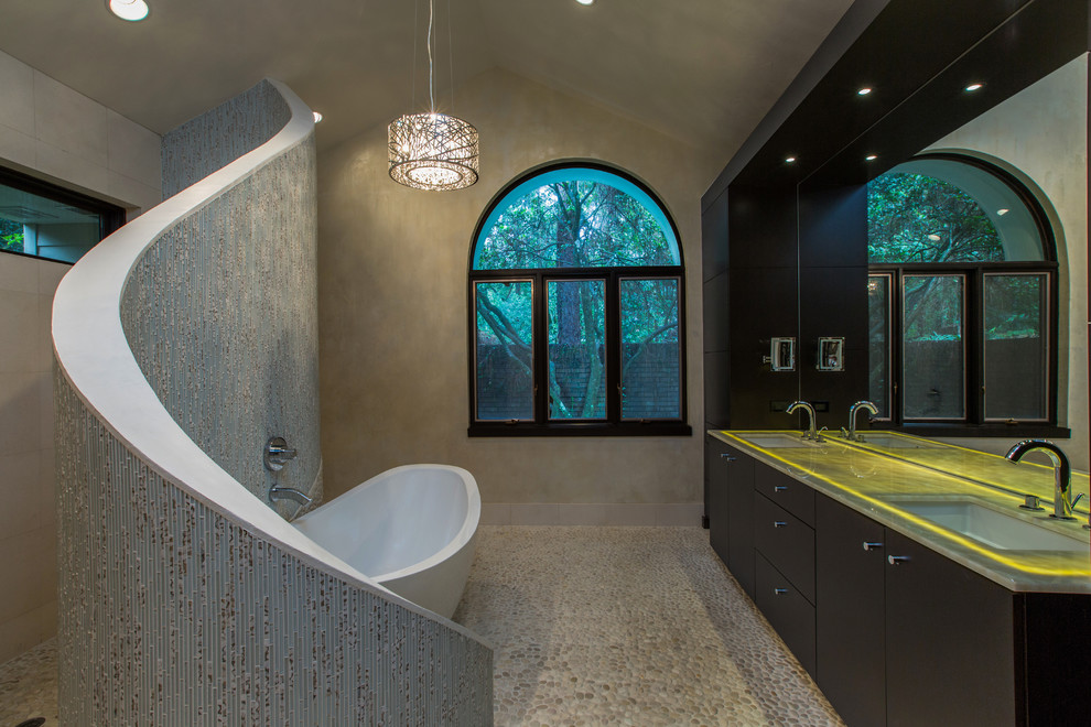Design ideas for a contemporary bathroom in Orlando with an undermount sink, flat-panel cabinets, black cabinets, a freestanding tub, an open shower, white tile, a one-piece toilet, onyx benchtops and an open shower.