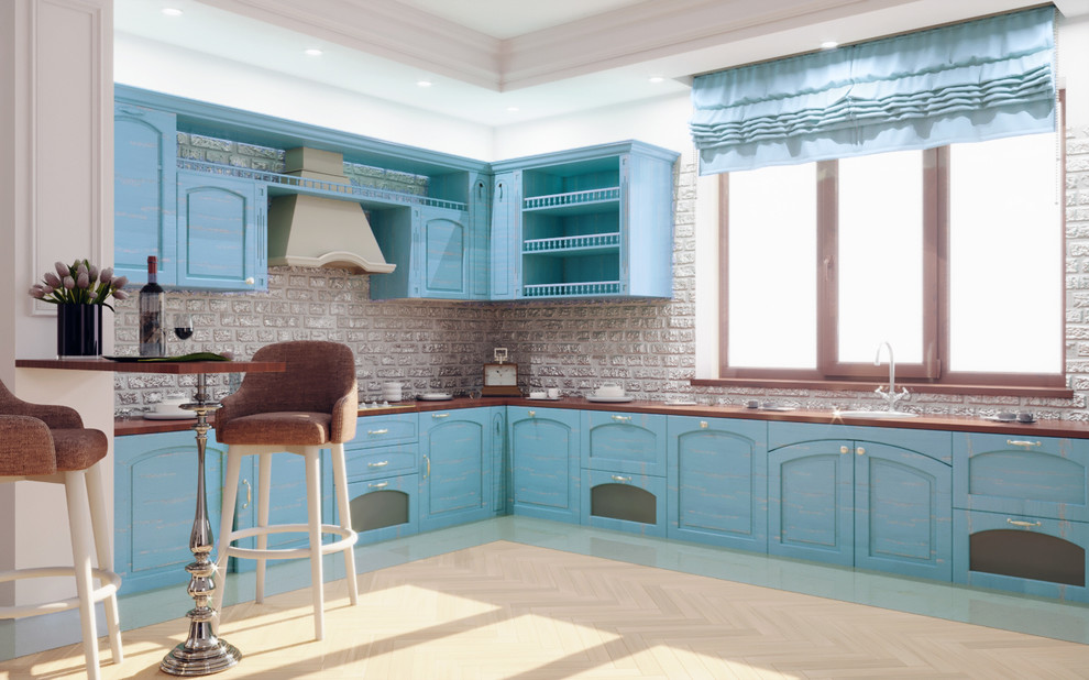 This is an example of a large transitional l-shaped eat-in kitchen in Other with an undermount sink, recessed-panel cabinets, turquoise cabinets, marble benchtops, grey splashback, brick splashback, white appliances, medium hardwood floors, no island and beige floor.