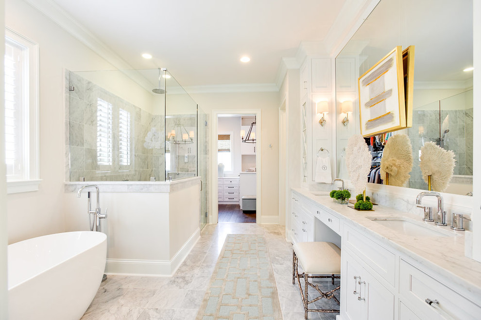 Inspiration for a large traditional master bathroom in Birmingham with beaded inset cabinets, white cabinets, a freestanding tub, a corner shower, white tile, marble, white walls, marble floors, an undermount sink, marble benchtops, yellow floor, a hinged shower door and white benchtops.