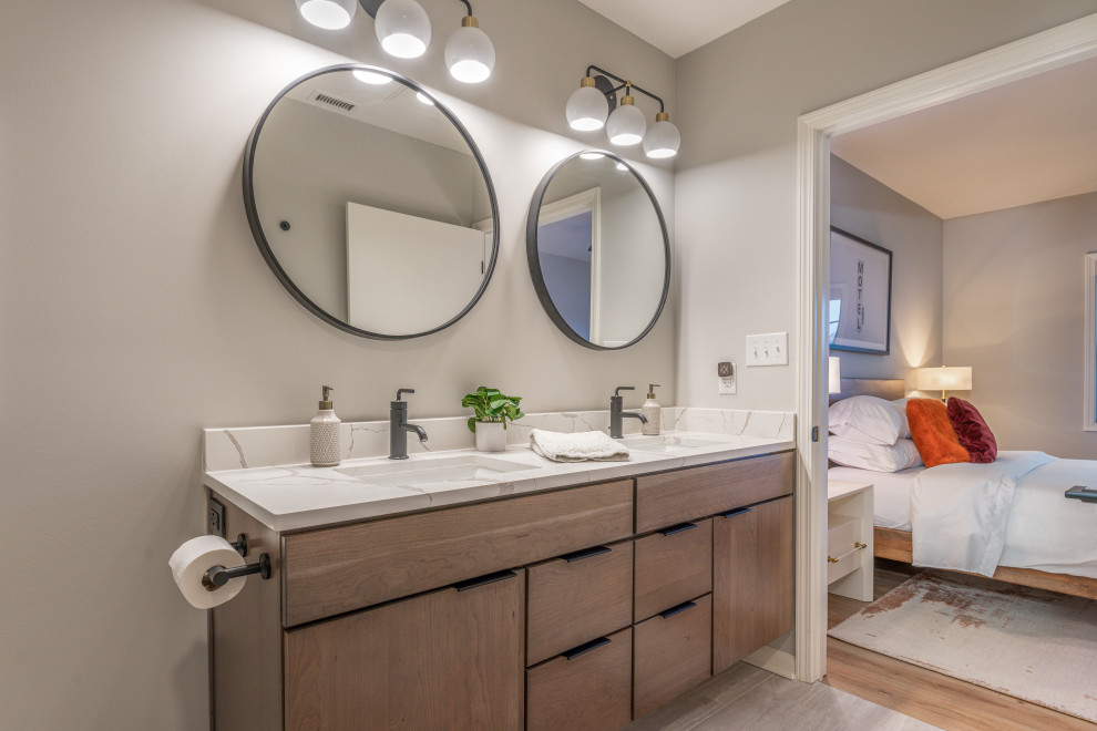 This is an example of a rustic bathroom in DC Metro with flat-panel cabinets, light wood cabinets, engineered stone worktops, double sinks and a floating vanity unit.
