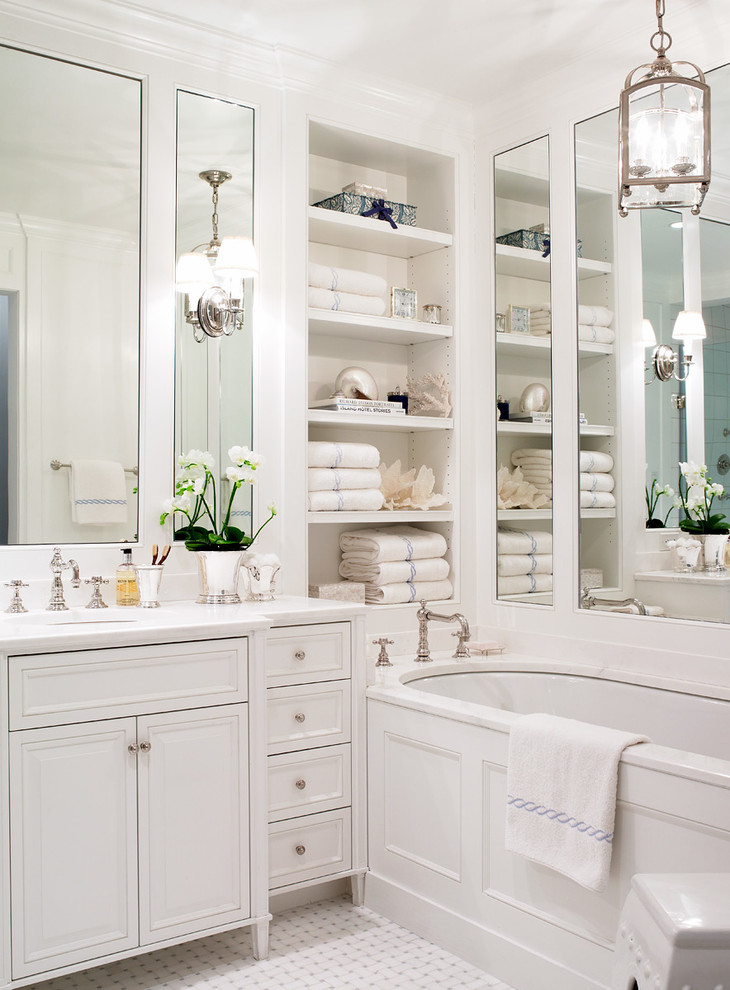 Small traditional master bathroom in New York with an undermount sink, white cabinets, marble benchtops, an undermount tub, white tile, white walls, mosaic tile floors, raised-panel cabinets and white benchtops.