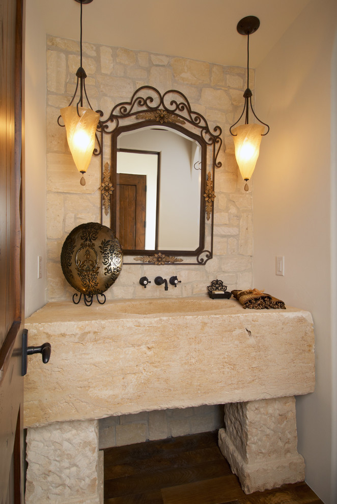 Photo of a large mediterranean powder room in Denver with white walls, dark hardwood floors, an integrated sink and limestone benchtops.