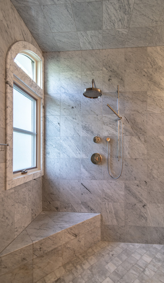 Large modern master bathroom in Denver with a corner shower, gray tile, grey floor, a hinged shower door, marble, grey walls and ceramic floors.