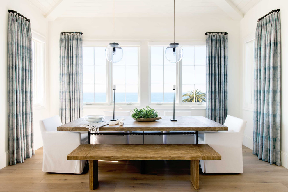 Design ideas for a beach style dining room in Los Angeles with white walls, medium hardwood floors, brown floor, timber and vaulted.