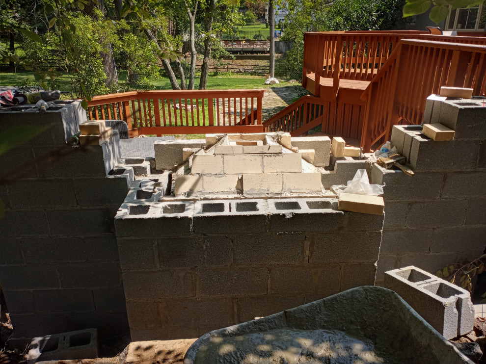 STONE FIREPLACE  , BBQ GRILL   AND STONE RETAINING WALL