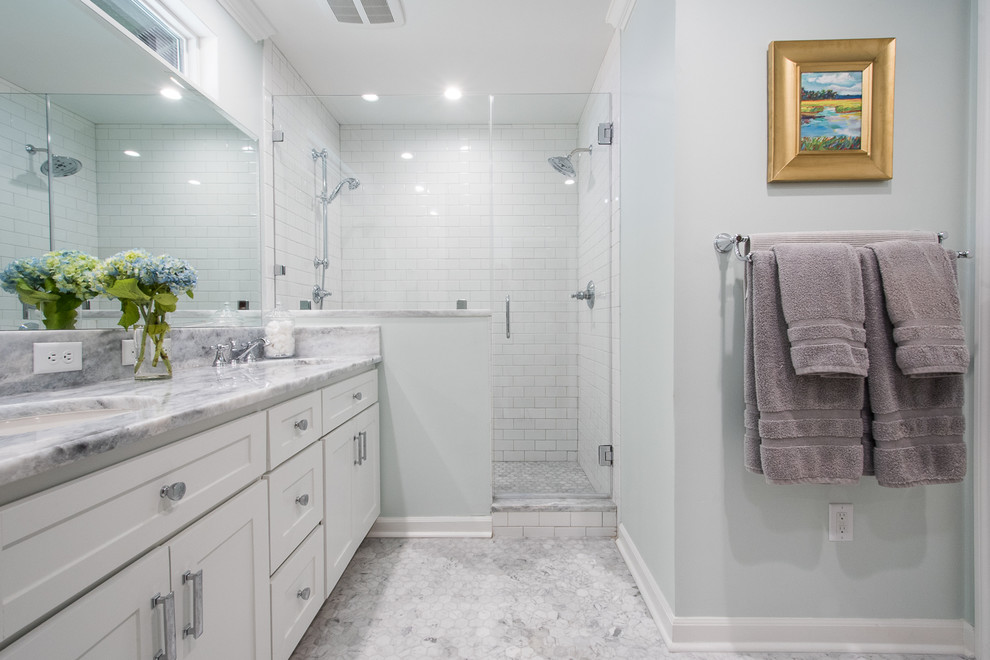 Inspiration for a mid-sized traditional master bathroom in Charleston with shaker cabinets, white cabinets, an alcove shower, white tile, subway tile, mosaic tile floors, an undermount sink, blue walls, marble benchtops and a hinged shower door.