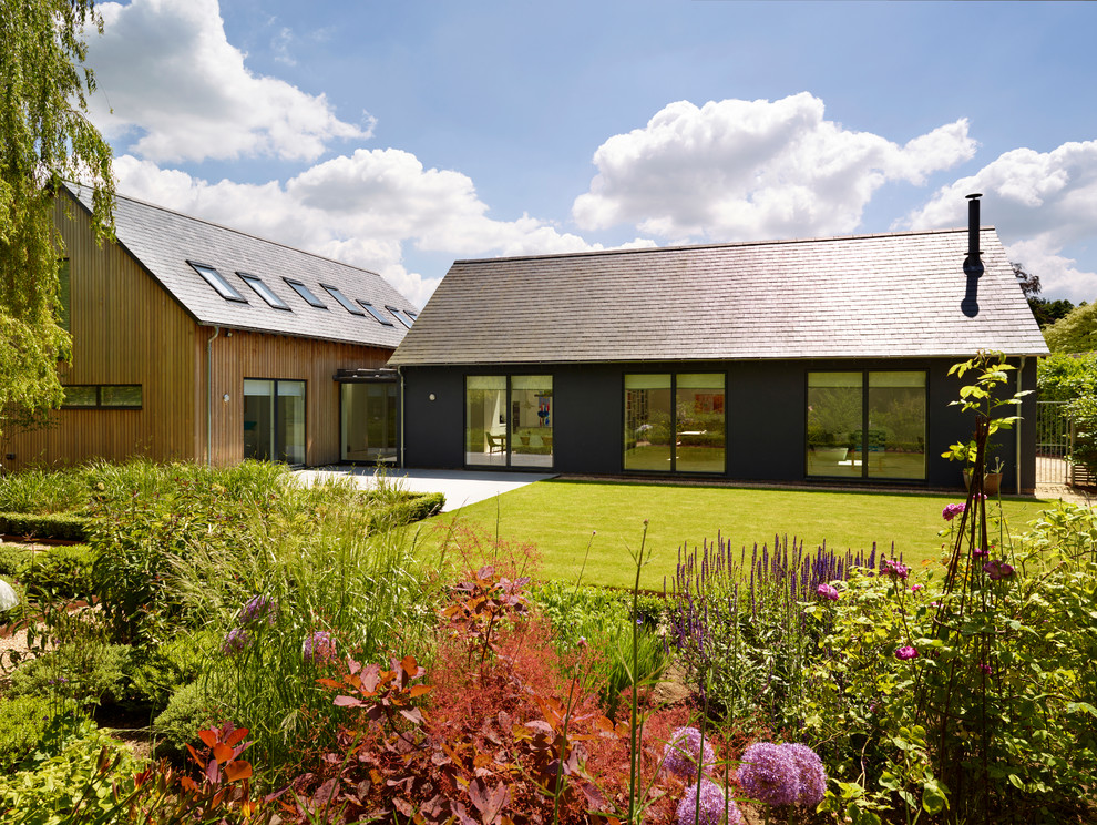 This is an example of a contemporary one-storey brown exterior in Cheshire with a gable roof.
