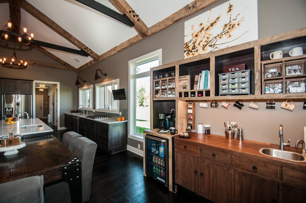 Inspiration for a rustic dark wood floor and brown floor eat-in kitchen remodel with an undermount sink, flat-panel cabinets, medium tone wood cabinets, quartz countertops, green backsplash and an island