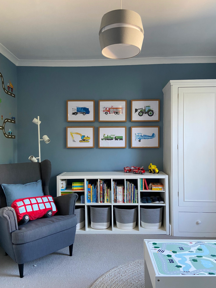 Toddler’s room for boys in London with blue walls, carpet and grey floors.