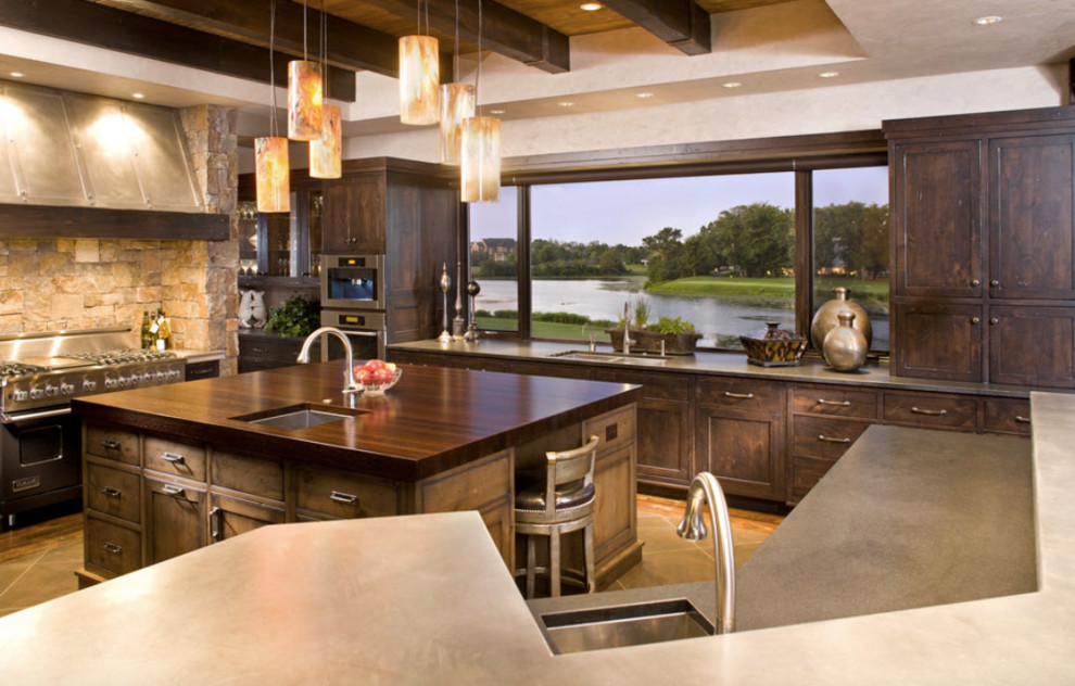 Example of a mid-sized mountain style galley light wood floor and beige floor eat-in kitchen design in Vancouver with a farmhouse sink, shaker cabinets, white cabinets, granite countertops, beige backsplash, ceramic backsplash, stainless steel appliances and no island