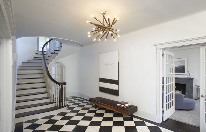 Photo of a mid-sized contemporary foyer in New York with white walls, marble floors, a double front door and a white front door.