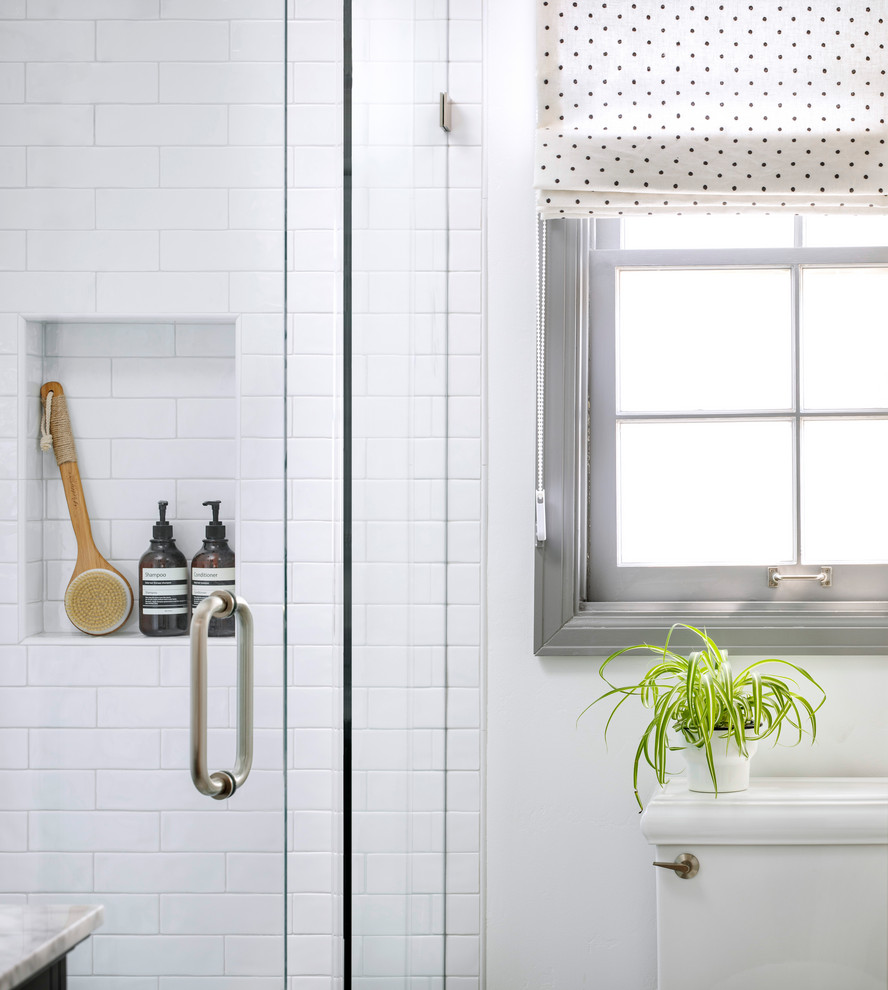 Small kids' white tile and ceramic tile concrete floor and gray floor corner shower photo in San Francisco with shaker cabinets, black cabinets, a one-piece toilet, white walls, an undermount sink, marble countertops, a hinged shower door and gray countertops