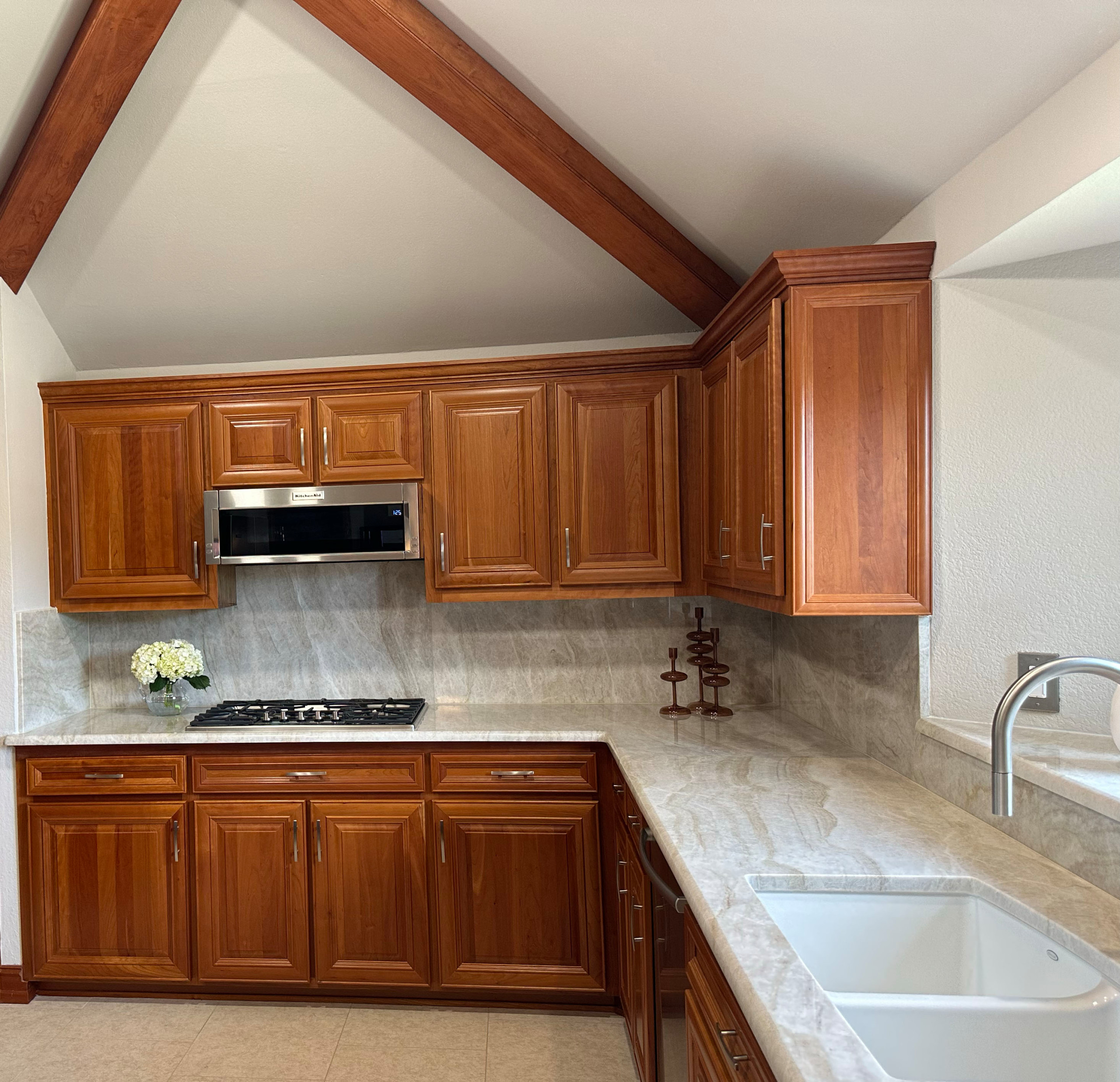Inspiration for a mid-sized transitional u-shaped ceramic tile, beige floor and exposed beam eat-in kitchen remodel in Dallas with a double-bowl sink, raised-panel cabinets, dark wood cabinets, quartz