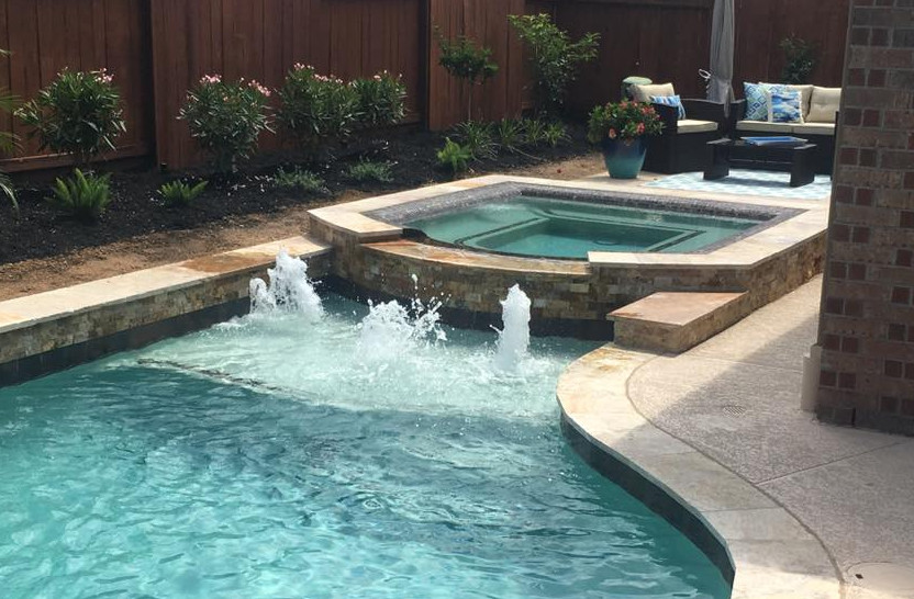 Mid-sized transitional backyard concrete and rectangular natural hot tub photo in Orange County