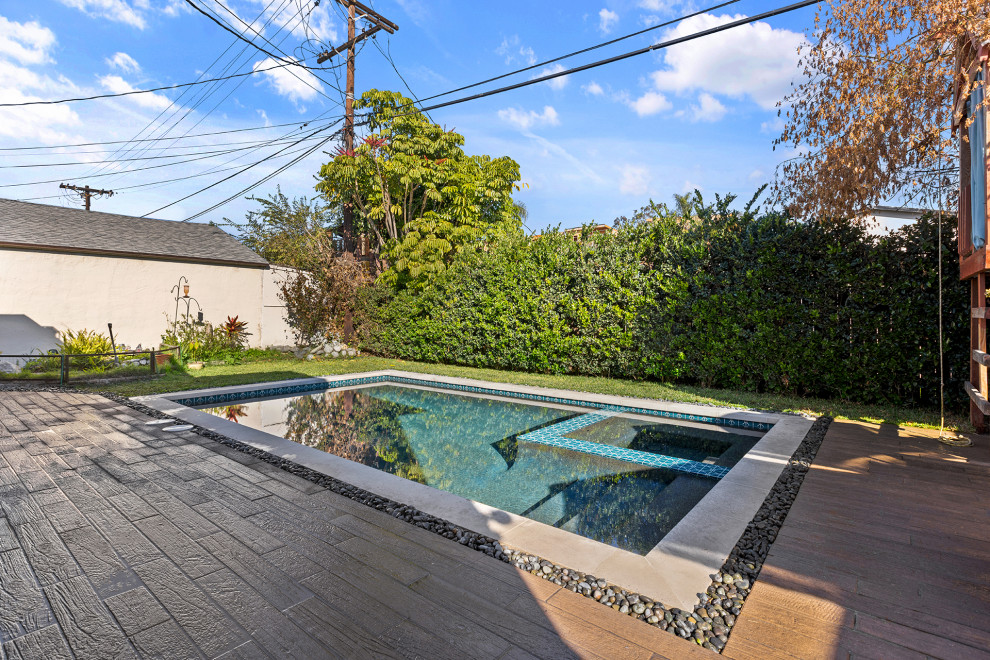 Inspiration for a mid-sized modern backyard rectangular lap pool in Los Angeles with with a pool and gravel.