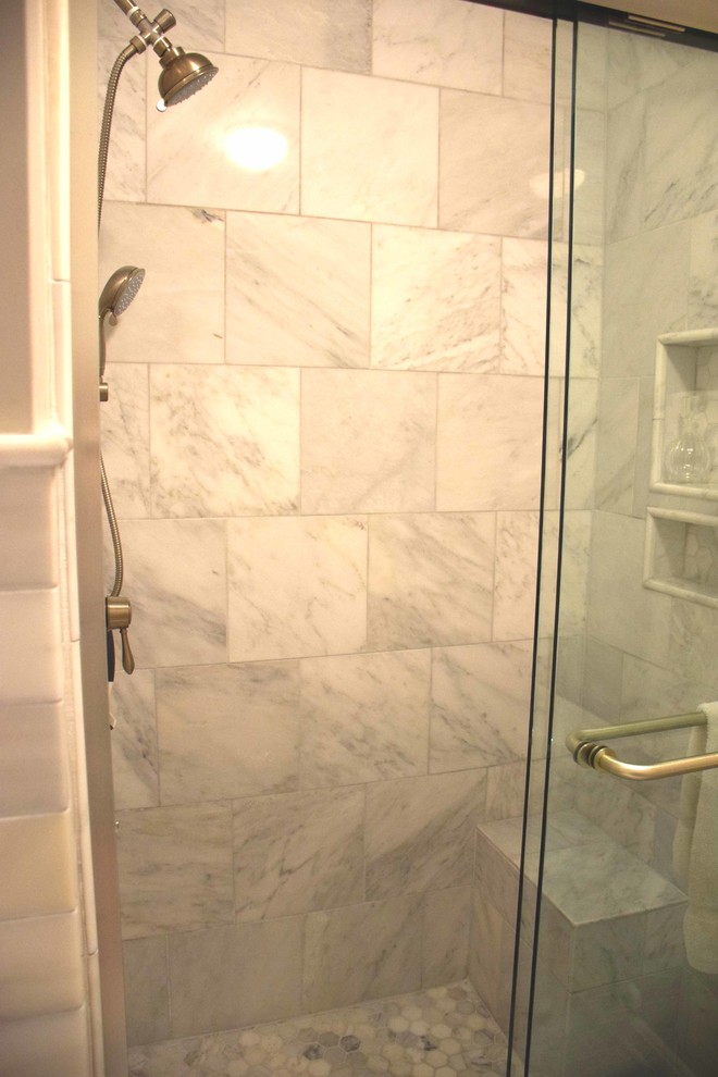 Design ideas for a large traditional master bathroom in Baltimore with raised-panel cabinets, medium wood cabinets, a drop-in tub, an alcove shower, a two-piece toilet, black and white tile, stone tile, grey walls, marble floors, an undermount sink and granite benchtops.