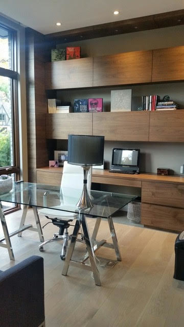 This is an example of a mid-sized modern study room in Toronto with grey walls, light hardwood floors, no fireplace, a freestanding desk and beige floor.