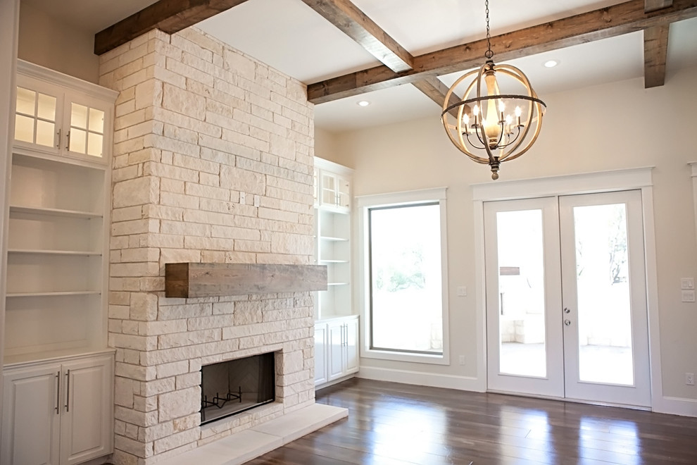 Photo of a large arts and crafts formal open concept living room in Austin with white walls, concrete floors, a standard fireplace, a stone fireplace surround and a wall-mounted tv.