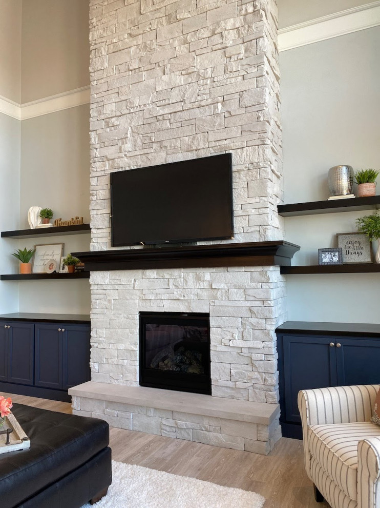This is an example of a large modern open concept living room in Other with a stone fireplace surround.