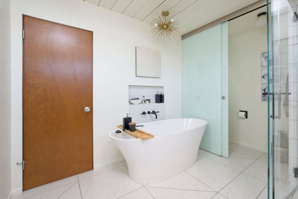 Design ideas for a mid-sized midcentury master bathroom in Orange County with flat-panel cabinets, dark wood cabinets, a freestanding tub, a corner shower, a two-piece toilet, white tile, ceramic tile, white walls, terrazzo floors, an undermount sink, engineered quartz benchtops, beige floor, a hinged shower door, white benchtops, a niche, a single vanity, a floating vanity and wood.