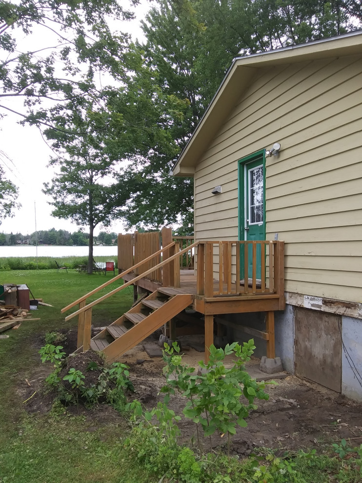 Large transitional backyard wood railing deck photo in Ottawa